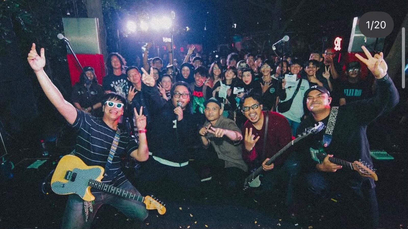 Musicians performing on stage with the crowd